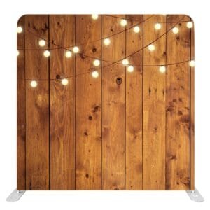 Rustic wood plank photo booth backdrop with warm hanging string lights