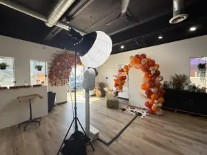 odern Pro-Bespoke photo booth setup with professional studio lighting and a camera in a luxury indoor venue.