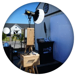 Outdoor luxury wooden photo booth with professional lighting and stylish prop table by Pro FX.