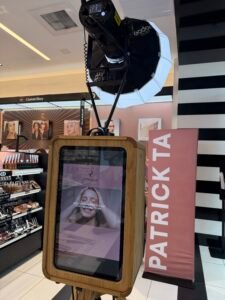 Pro-Signature 7 ro-Elegance handcrafted wood photo booth at a Patrick Ta Beauty brand activation with custom branded vinyl and studio lighting.